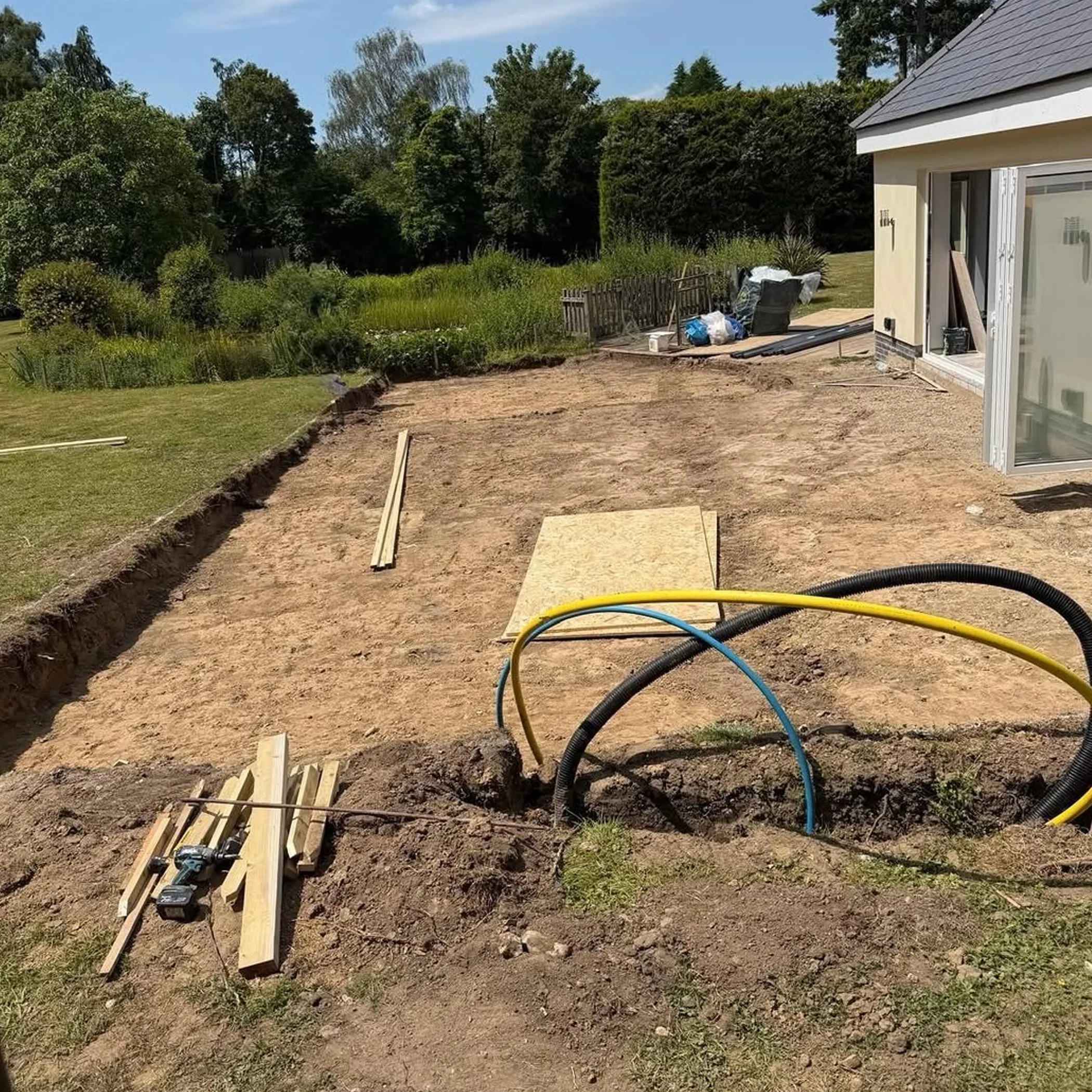 excavation and utility conduits for patio concrete